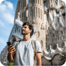 Young tourist looking at their phone outside Sagrada Familia